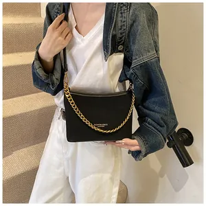 Detail of black leather bucket bag with gold chain strap and Fashion & Bags text logo