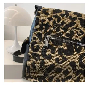 Detail of the leopard print woven fabric and smooth metal zipper on the tote bag
