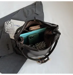 Internal view of a leather tote bag showing spacious capacity for a tablet and umbrella