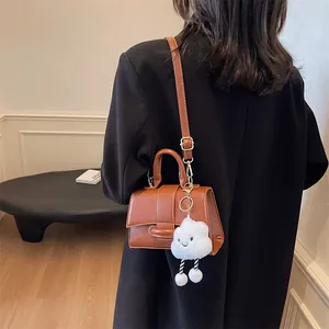 Brown vintage leather crossbody shoulder bag with a cute white cloud plush pendant