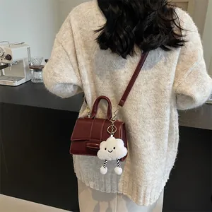 Retro deep red square shoulder bag with smooth finish and plush cloud charm accessory