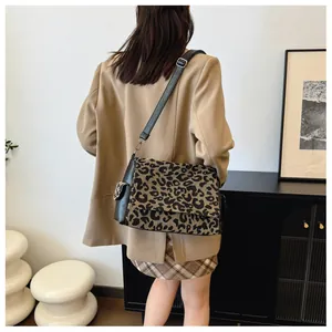 Leopard print crossbody bag with black leather trim and silver hardware detail