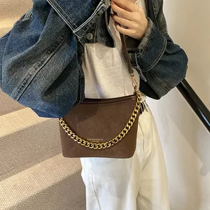 Dark brown suede bucket bag with gold chain strap and leather handle for women