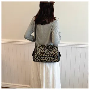Detailed back view of a woman wearing the leopard print tote bag with a slim strap