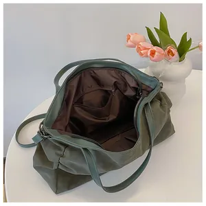 Detail view of large olive green tote bag interior with fabric lining and zipper pocket