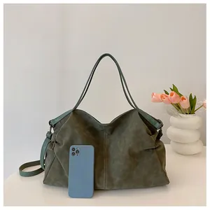 Olive green tote bag detail showing large capacity, suede texture, and size comparison