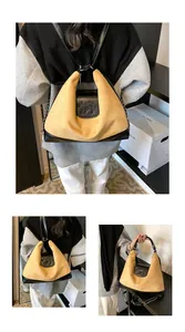 Detail showing the yellow suede and black leather bag with embossed elephant logo