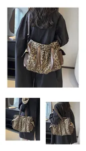 Detail of leopard print tote bag with brown faux leather trim and adjustable shoulder strap