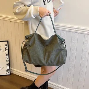 Large dark green suede tote bag for women with minimalist drawstring design and strap