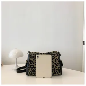 Detailed view of leopard print jacquard tote bag next to a tablet for size reference