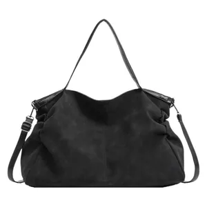 Minimalist black matte large tote hobo bag with wide shoulder strap for daily commuting
