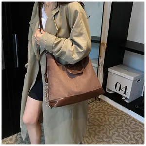 Brown frosted suede tote bag with cartoon bear detail and elegant metal chain strap