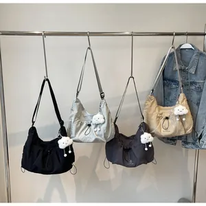 Detailed view of large crossbody bags in four colors with drawstring and cloud charm