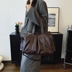 Retro dark brown leather tote bag with adjustable shoulder strap for casual use