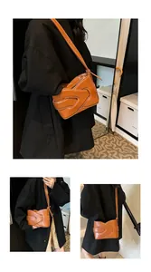 Detail of brown PU leather shoulder bag featuring unique overlapping hand design and white stitching