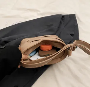 Internal capacity of the moon-shaped underarm bag showing space for daily essentials