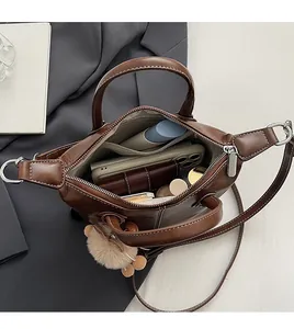 Macro view of brown leather tote bag interior showing large capacity for essentials