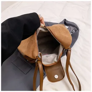 Detailed interior of the brown tote bag featuring a chevron lining and magnetic snap closure