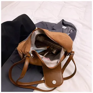 Detailed internal view of brown matte leather bag showing large capacity for essentials