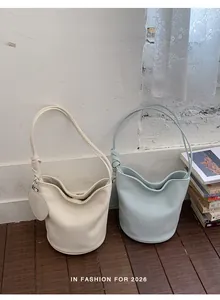Detailed texture of lychee grain leather bucket bags with knot strap and round mini pouch
