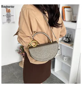 Detailed view of champagne gold sequined crescent bag with metallic handle and strap