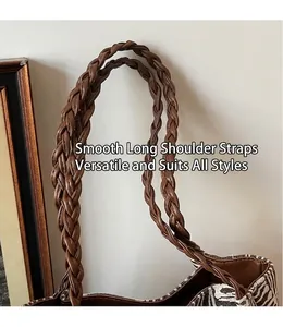 Detail of the braided brown PU leather strap on a zebra print canvas tote bag
