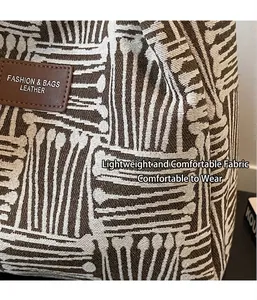 Close-up of woven tote bag fabric texture with brown leather fashion logo patch