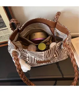 Detail view of large canvas tote bag with woven rope handles and spacious interior storage