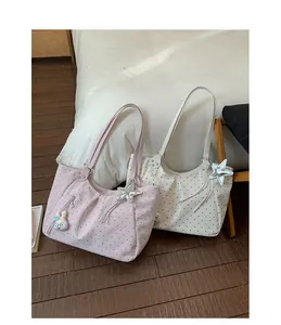 Detailed view of polka dot nylon tote bags with star charms and ruched design accents