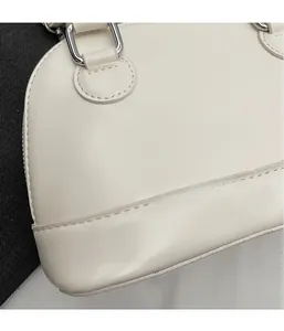 Detail of white shell handbag with premium leather texture and silver metal hardware
