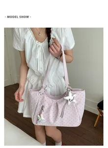 Detailed shot of lavender polka dot tote bag with star charm and plush bunny accessory