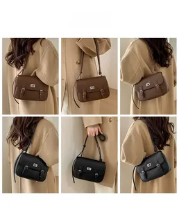 Mini vintage satchel detail showcasing lychee texture leather and classic metal turn-lock
