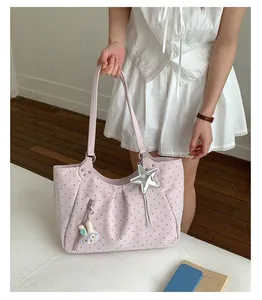 Detailed view of pink polka dot tote bag, large capacity single shoulder college style.