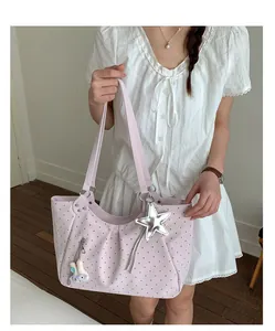 Details of the stylish polka dot tote bag featuring a cute star pendant and spacious design.