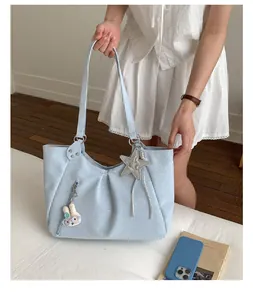 Light blue polka dot tote bag with cute star and rabbit pendants for daily women fashion.