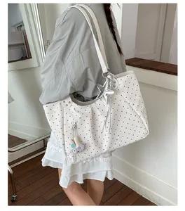 Spacious white polka dot tote bag styled on a model for a trendy and casual everyday look