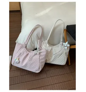 Detail shot of polka dot tote bags in pink and beige colors for casual daily use.