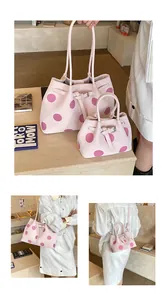 Dettaglio del set di borse tote rosa a pois con cinturini regolabili e fibbie in metallo