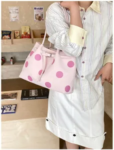 Dettaglio della borsa tote rosa a pois viola con cinturino decorativo con fibbia laterale