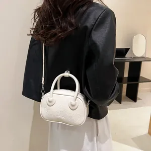 Dettaglio della borsa in ecopelle bianco crema con scritta fashion e finitura testurizzata