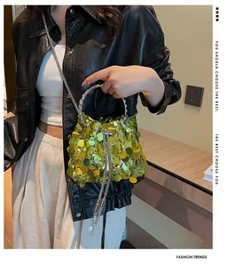 Detailed close-up of lime green sequin bucket bag with silver ring handle and chain