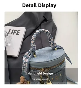 Detail of blue denim bucket bag with quilted patterns and silk scarf handle