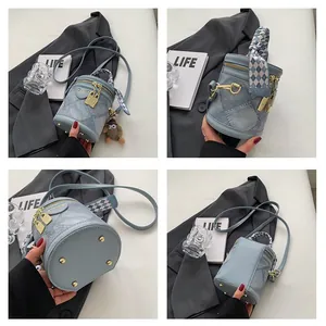 Multiple views of light blue denim texture bucket bag with silk scarf and monster charm