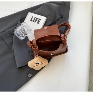 Brown retro leather small square crossbody bag with a star plush pendant and magnetic flap