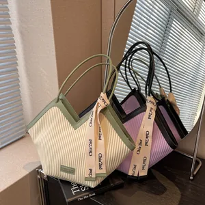 Minimalist V-shaped textured canvas tote bag with stylish ribbon detail and double handles