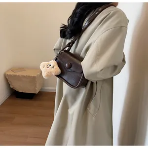 Retro dark brown crossbody bag with a cute beige plush star charm detail and PU leather texture