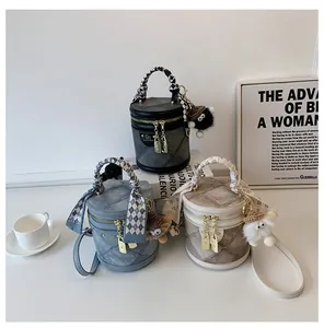 Quilted bucket bag with silk scarf handle and plush toy charm in three colors