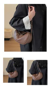 Detail view of brown pebbled leather crossbody bag with adjustable strap and gold hardware