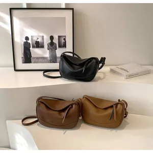 Three half-moon leather crossbody bags in black, dark brown, and light coffee colors