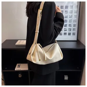 Detail of cream white pleated shoulder bag featuring lychee grain texture leather